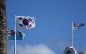The flags of Fiji and Korea flying in Suva