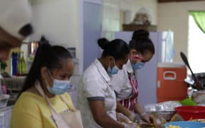 Despite the tragedy, many Samoans are giving generously to try and help. These people are chopping food as part of grassroots charity Helping Hands.