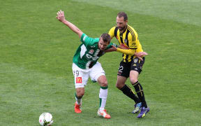 Jets' Joel Griffiths holds off the challenge from Phoenix' Andrew Durante during their A-League Football Match - Phoenix v Newcastle at the Westpac Stadium in Wellington on 26th of October 2014.