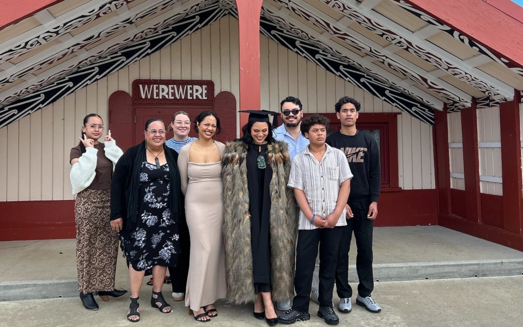 Angel Stewart, wahine Māori lawyer and content creator with her whānau back home outside Werewere whare.