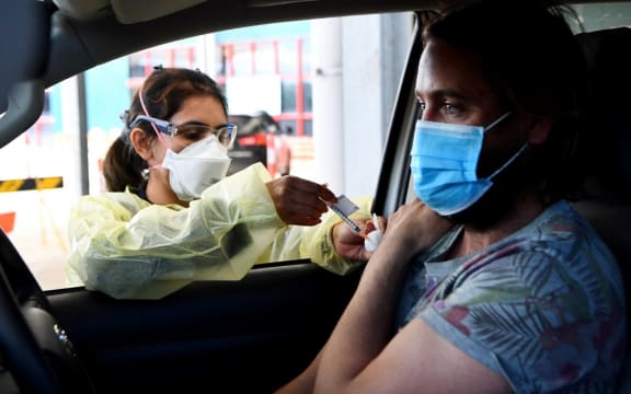 A resident receives a dose of the Pfizer Covid-19 vaccine in the outer Melbourne suburb of Melton on August 10, 2021.