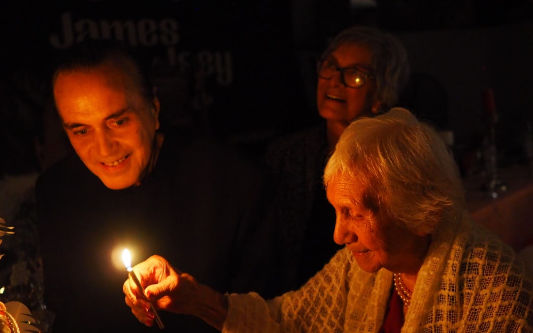 Isey Cross, 106, about to blow out one of the candles from her birthday cake.