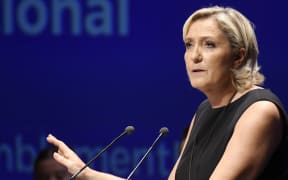 Leader of France's Rassemblement National (RN) far-right political party Marine Le Pen gestures as she delivers a speech at a meeting in Fréjus, southern France on September 16, 2018.