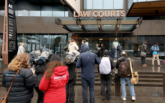Journalists gather outside the Christchurch District Court ahead of alleged gunman Brenton Tarrant's appearance for his hearing via audio-visual link from a maximum-security prison in Auckland.