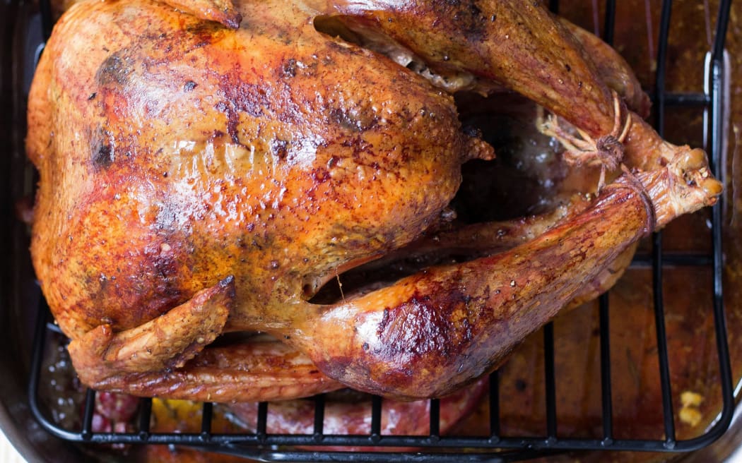 A whole roasted duck on a rack