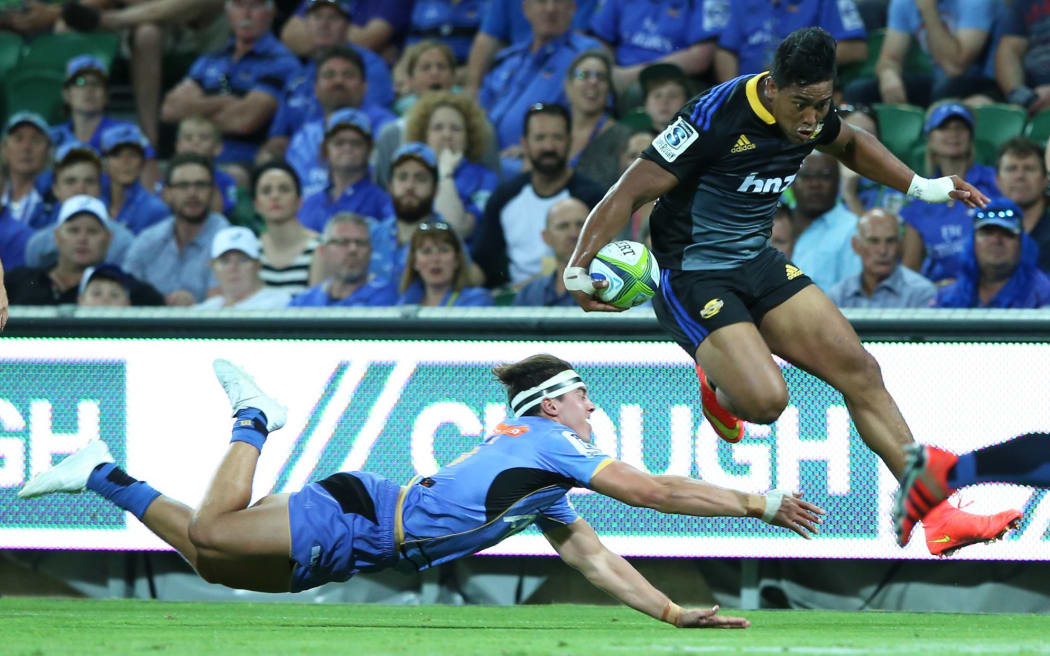 Hurricanes star Julian Savea hurdles a Force defender