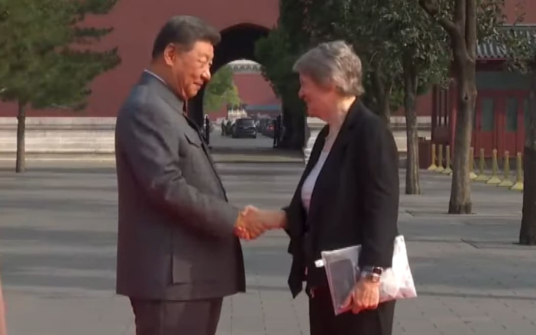Former New Zealand Prime Minister Helen Clark shakes hands with China President Xi Jinping before a parade to mark 80 years since the end of World War II.