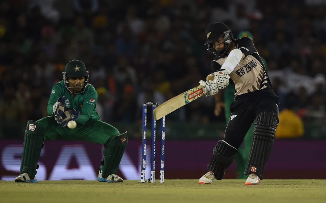 New Zealand's Kane Williamson plays a shot as Pakistan's wicketkeeper Sarfaraz Ahmed looks on during the World T20 cricket match between New Zealand and Pakista