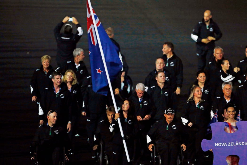 New Zealand's flag bearer and javelin competitor Holly Robinson leads the team at the opening ceremony.