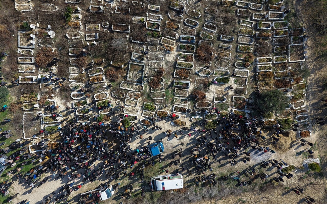 People attend a funeral procession on March 8 in al-Janoudiya, a town west of Idlib, for four Syrian security forces members killed in the clashes.