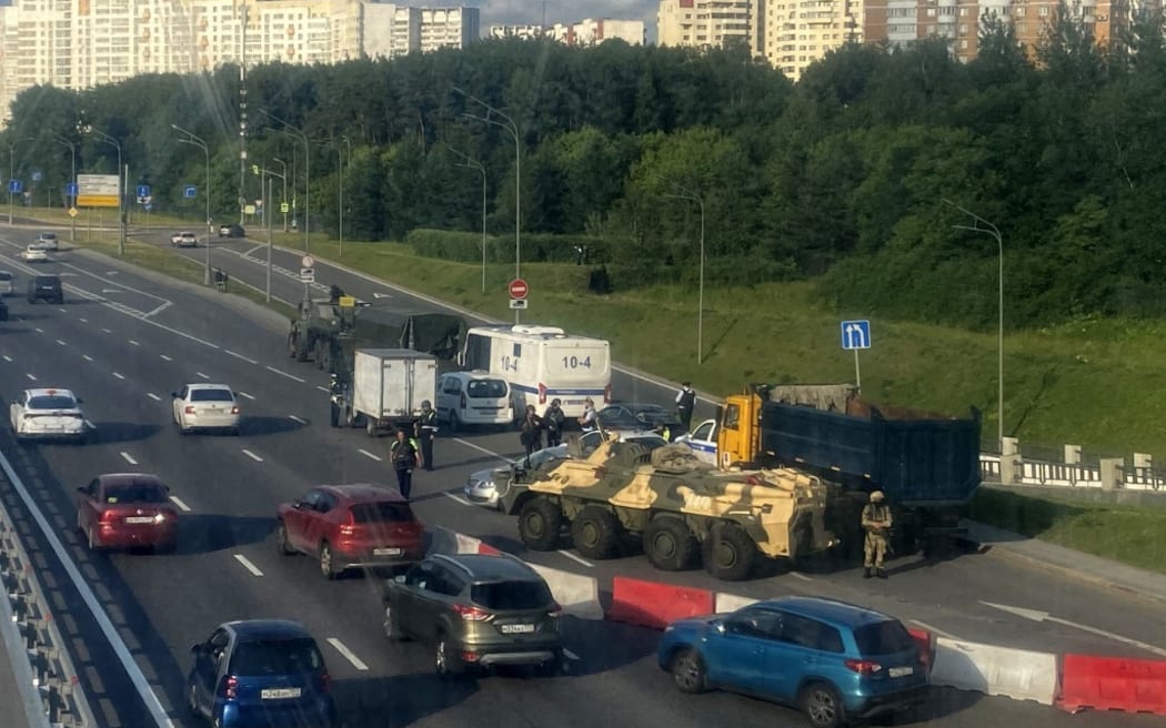 Russian police officers, traffic police officers and servicemen block part of a highway entering Moscow on June 24, 2023.