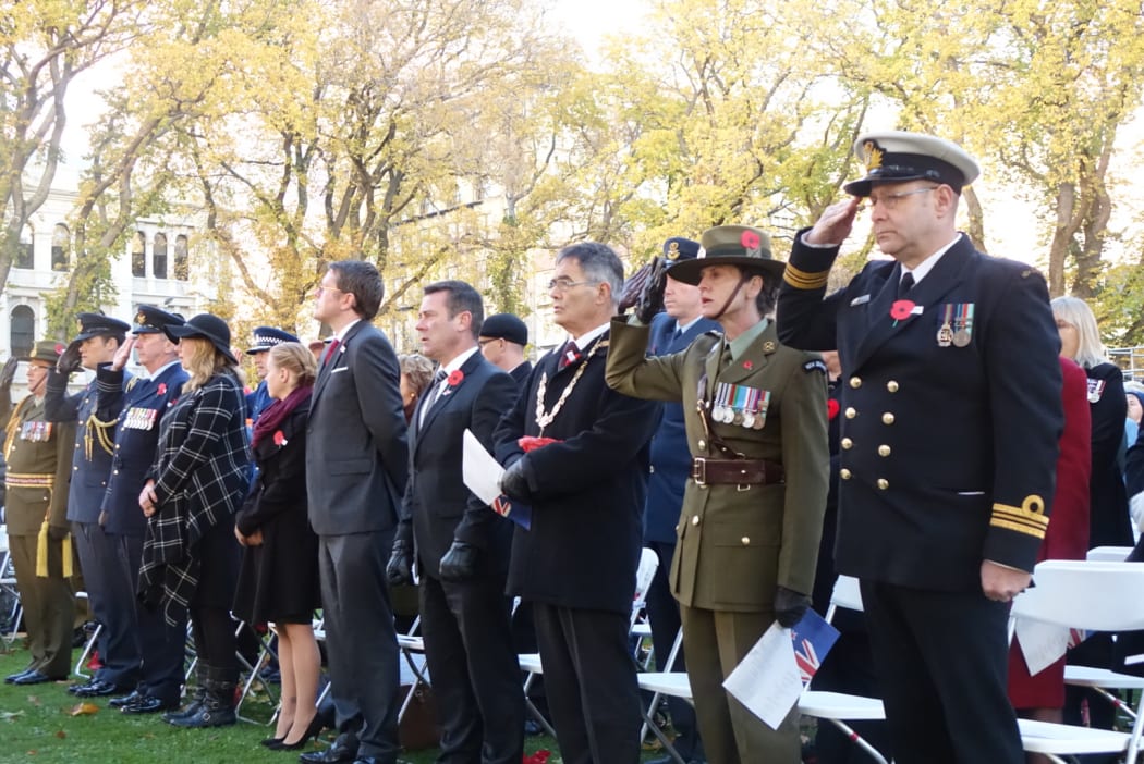 Guests salute to remember the fallen at the service in Dunedin.