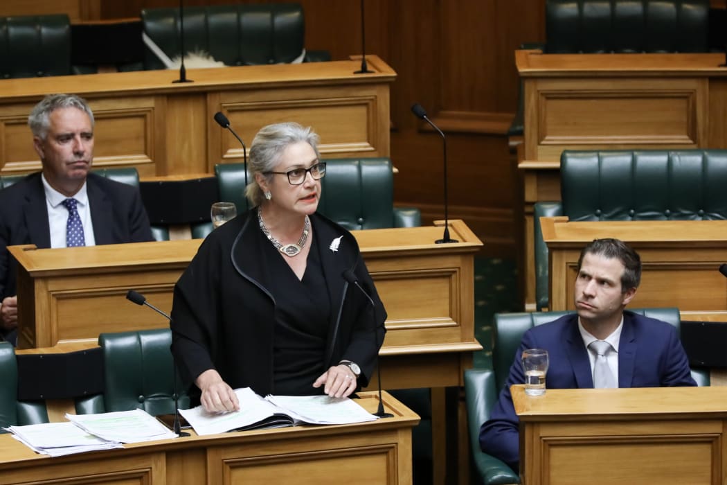 National MP Harete Hipango wears black to signify the import of the debate. She is watched by her fellow National MPs Lawrence Yule and Chris Penk.