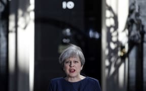 FILE - In this Tuesday, April 18, 2017 file photo, Britain's Prime Minister Theresa May arrives to speak to the media outside her official residence of 10 Downing Street in London.