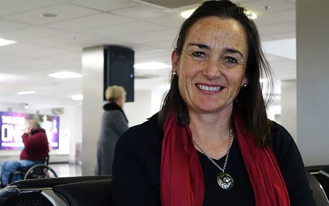 Agri consultant Alison Dewes sits at Auckland domestic airport