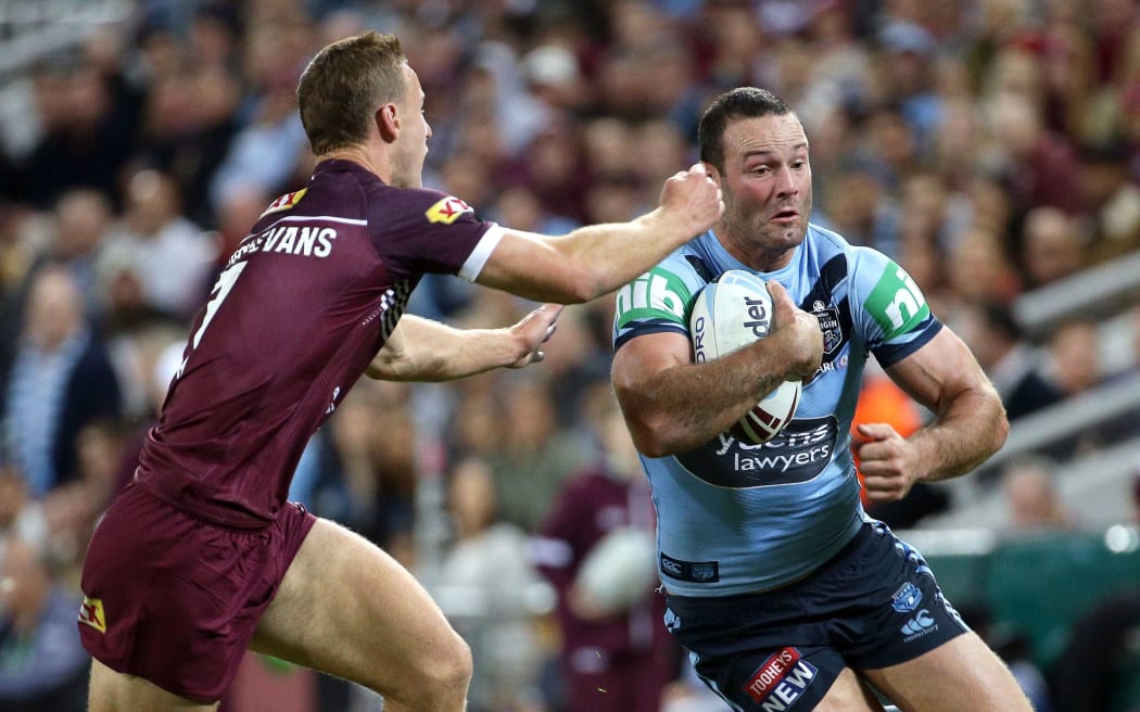 Daly Cherry-Evans, left, of Queensland tries to stop Boyd Cordner, right, of New South Wales during the Queensland  v NSW State Of Origin in 2019.