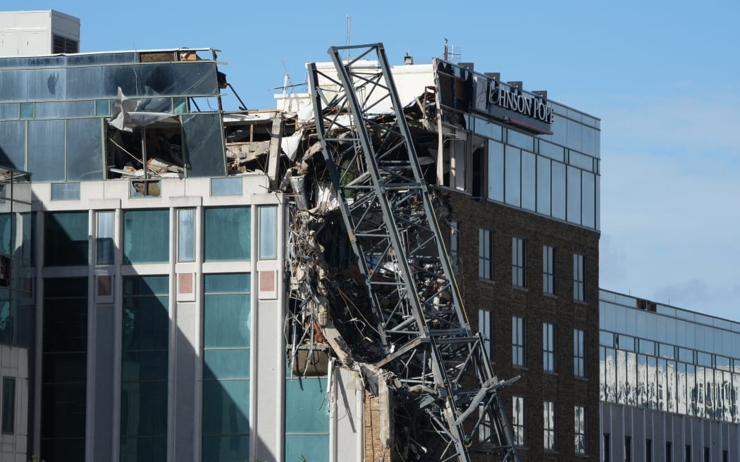 A crane that collapsed into a building is seen in downtown St. Petersburg due to Hurricane Milton on October 10, 2024 in Florida. At least four people were confirmed killed as a result of two tornadoes triggered by Hurricane Milton on the east coast of the US state of Florida, local authorities said Thursday. (Photo by Bryan R. SMITH / AFP)