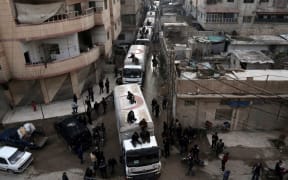 A Red Crescent aid convoy arrives in Kafr Batna on the outskirts of the capital Damascus on February 23, in cooperation with the UN to deliver aid to thousands of besieged Syrians during a partial ceasefire.