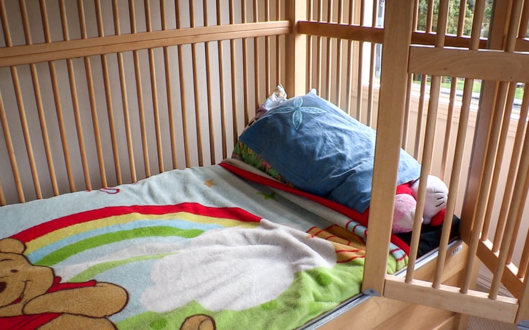 Devora Busch's daughter Rheegan's bed, which has safety bars around it.