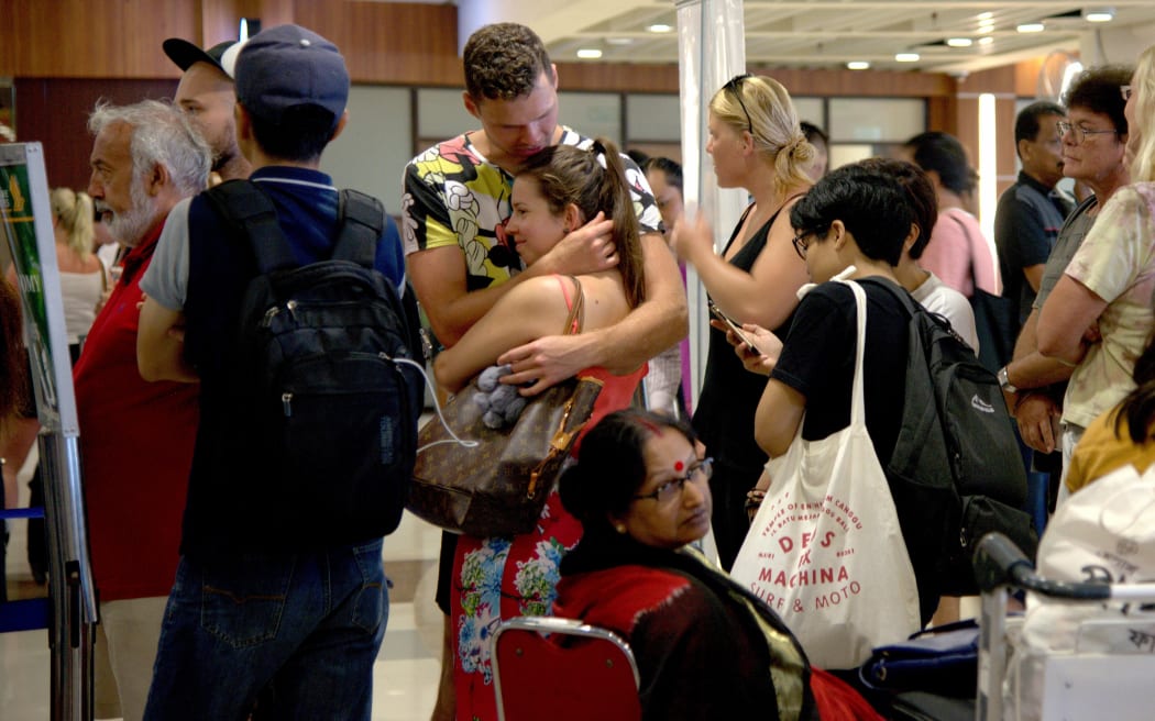 Passengers trapped by cancelled flights due ot ash from Mt Agung at the Ngurah Rai International airport in Denpasar, Bali.