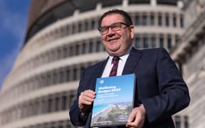 Finance minister Grant Robertson showing the cover of Budget 2023 the day before its reveal