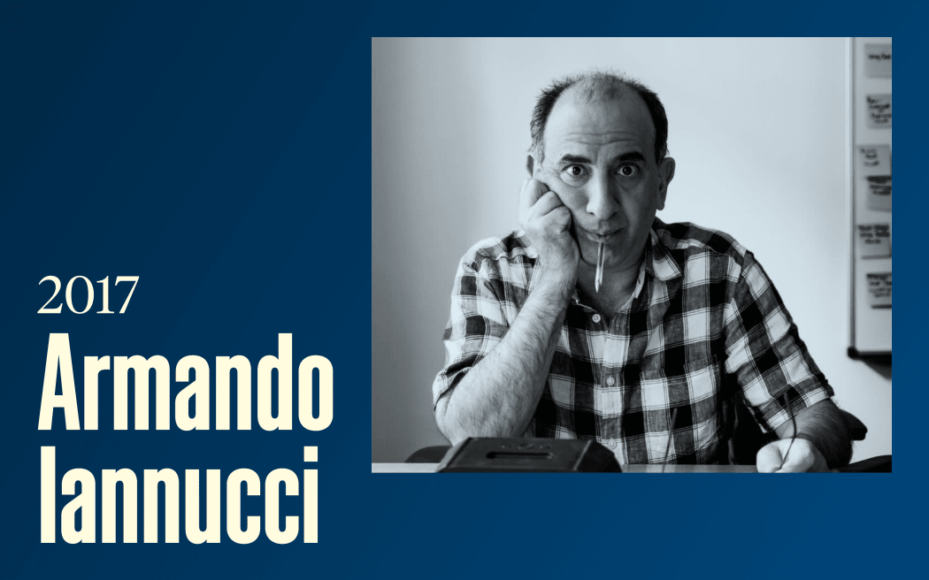 A man looks comically at the camera with a pen in his mouth, text reads "2017, Armando Iannucci"