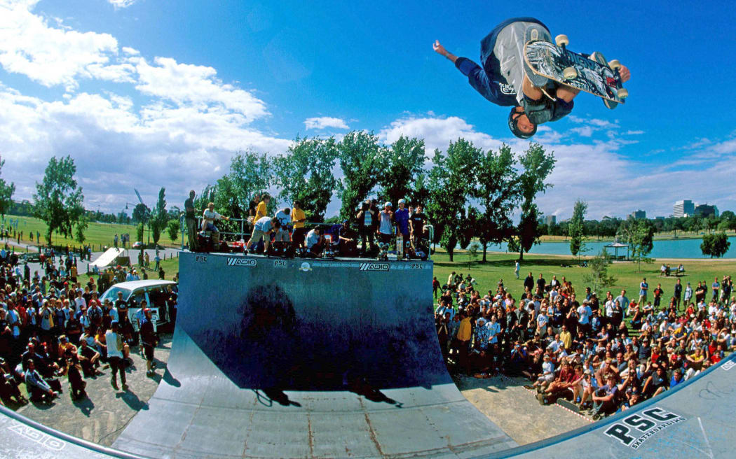 A skateboarder riding a halfpipe.