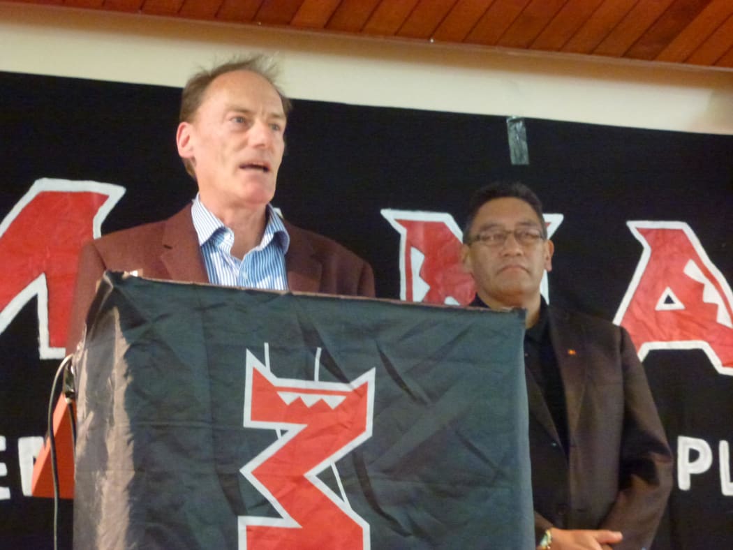 John Minto at the podium with Mana Party leader Hone Harawira.