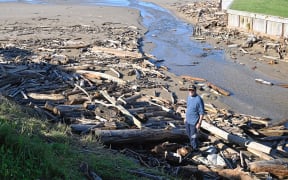 Gisborne local Graham Breckell stands beside the Wainui Stream debris build-up. Picture by Paul Rickard (LDR single use only)