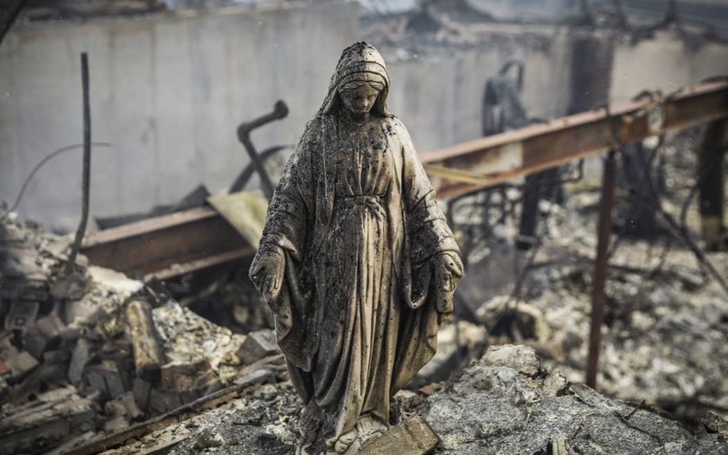 LOUISVILLE, CO - DECEMBER 31: A statue of Virgin Mary remains standing amidst the rubble of a home on December 31, 2021 in the aftermath of the Marshall Fire.