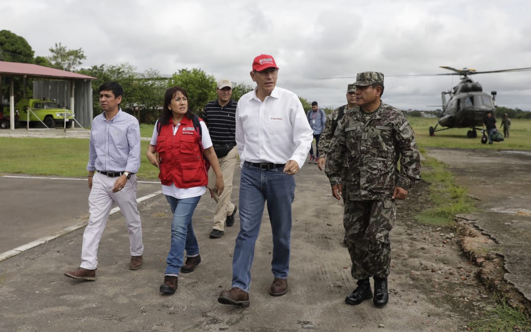 Peru's President Martin Vizcarra (2-R) arrives at an airport in Yurimaguas before touring the area affected by a quake in the Amazon region in Peru, on May 26, 2019.