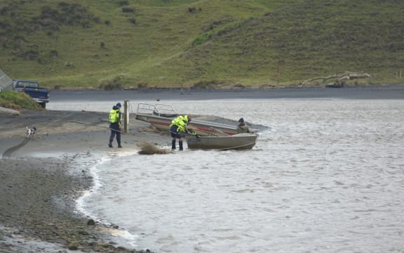 Locals and Landsar personnel at the Marokopa River estuary during the search for Thomas Phillips and his children.