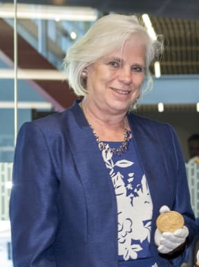 Dr Mary Fowler, great granddaughter of  Ernest Rutherford, whose Nobel medal she is holding.