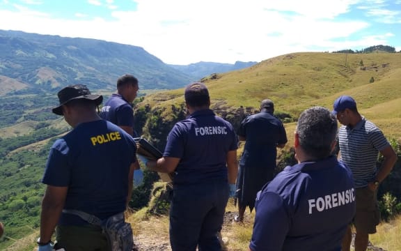 Police investigators in the Nausori Highlands following the deaths of  five members of the same family.