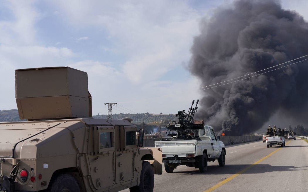 Syrian forces drive toward rising smoke in Latakia on March 7.