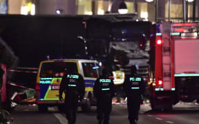 Police walk before the truck that had sped into a Christmas market in Berlin, on 19 December 2016.