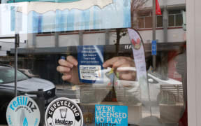 A sticker in the window of Atrium Cafe, Lower Hutt to let people with bowel disease use their toilets.