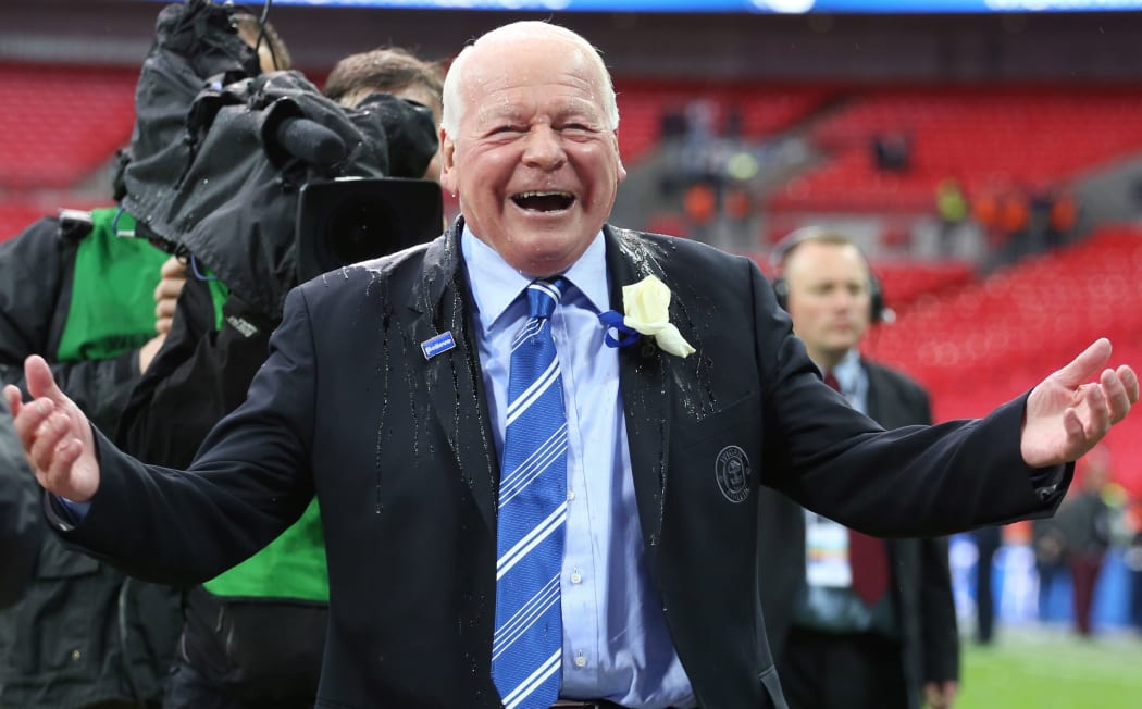 The Wigan Athletic chairman Dave Whelan laughs as he is soaked with champagne.