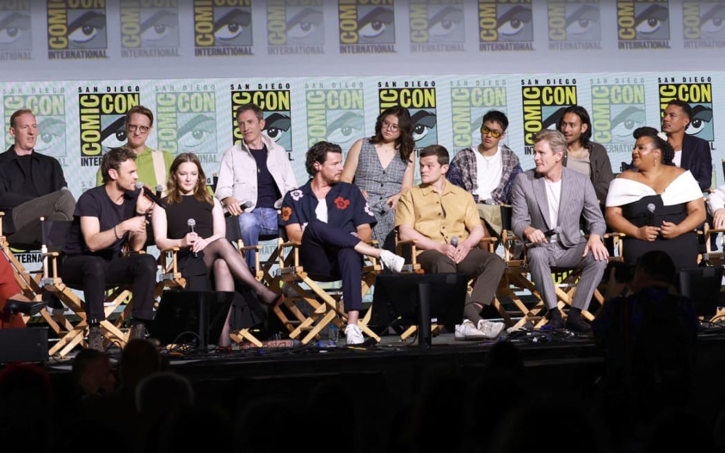 SAN DIEGO, CALIFORNIA - JULY 26: (L-R) Yvette Nicole Brown, Patrick Mckay, Charlie Vickers, JD Payne, Morfydd Clark, Daniel Weyman, Benjamin Walker, Megan Richards, Robert Aramayo, Tyroe Muhafidin, Charles Edwards, Maxim Baldry, Sophia Nomvete, Ismaël Cruz Córdova, Ema Horvath, Lloyd Owen, Trystan Gravelle and Cynthia Addai-Robinson speak onstage during "The Lord Of The Rings: Rings Of Power" Panel during 2024 Comic-Con International at San Diego Convention Center on July 26, 2024 in San Diego, California.   Matt Winkelmeyer/Getty Images/AFP (Photo by Matt Winkelmeyer / GETTY IMAGES NORTH AMERICA / Getty Images via AFP)