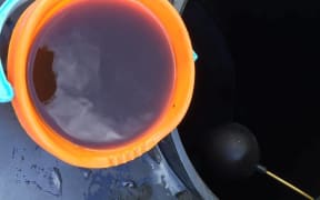 A bucket showing Kaeo's tap water.