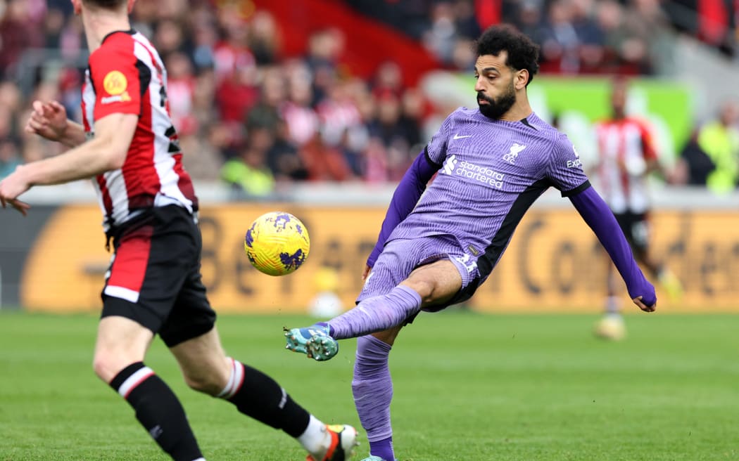 Liverpool's Egyptian striker #11 Mohamed Salah passes the ball during the English Premier League football match between Brentford and Liverpool at the Gtech Community Stadium in London on February 17, 2024. (Photo by Adrian DENNIS / AFP) / RESTRICTED TO EDITORIAL USE. No use with unauthorized audio, video, data, fixture lists, club/league logos or 'live' services. Online in-match use limited to 120 images. An additional 40 images may be used in extra time. No video emulation. Social media in-match use limited to 120 images. An additional 40 images may be used in extra time. No use in betting publications, games or single club/league/player publications. /
