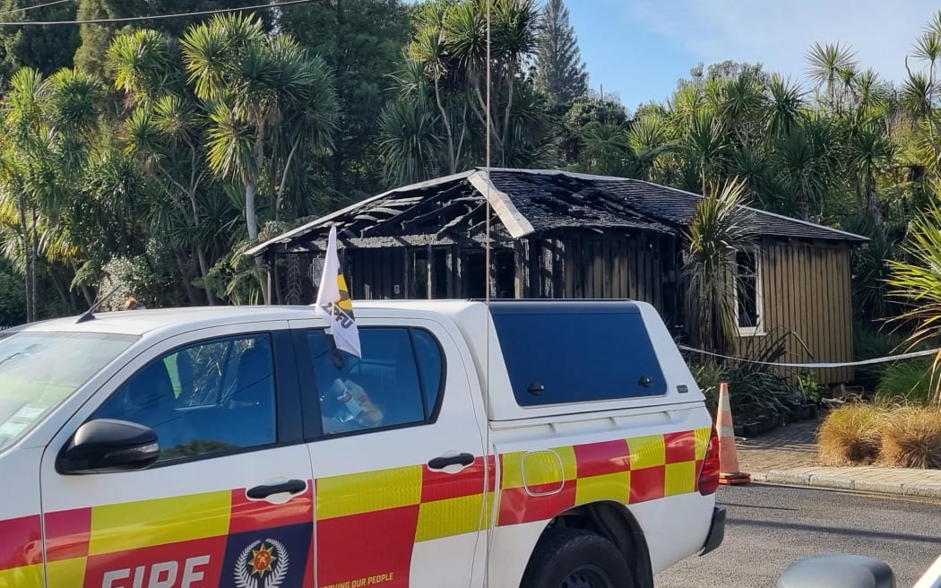 A wooden building damaged by fire.