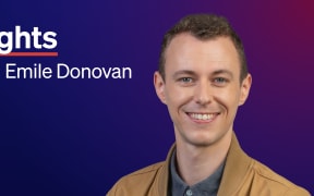 A smiling main with short brown hair wearing a collared shirt buttoned up and a casual brown jacket. Text reads "Nights with Emile Donovan" and in the corner is an RNZ tohu.