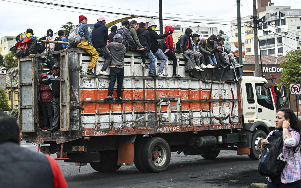 Ecuadorean indigenous ride on top of a truck heading to the House of Culture, in Quito.