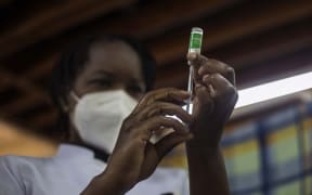 A nurse at Kenyatta National Hospital fills a syringe from a vial of the Covid-19 Covishield vaccine, the Indian version of the Oxford-AstraZeneca vaccine produced by the Serum Institute of India, the world's largest vaccine manufacturer by volume.