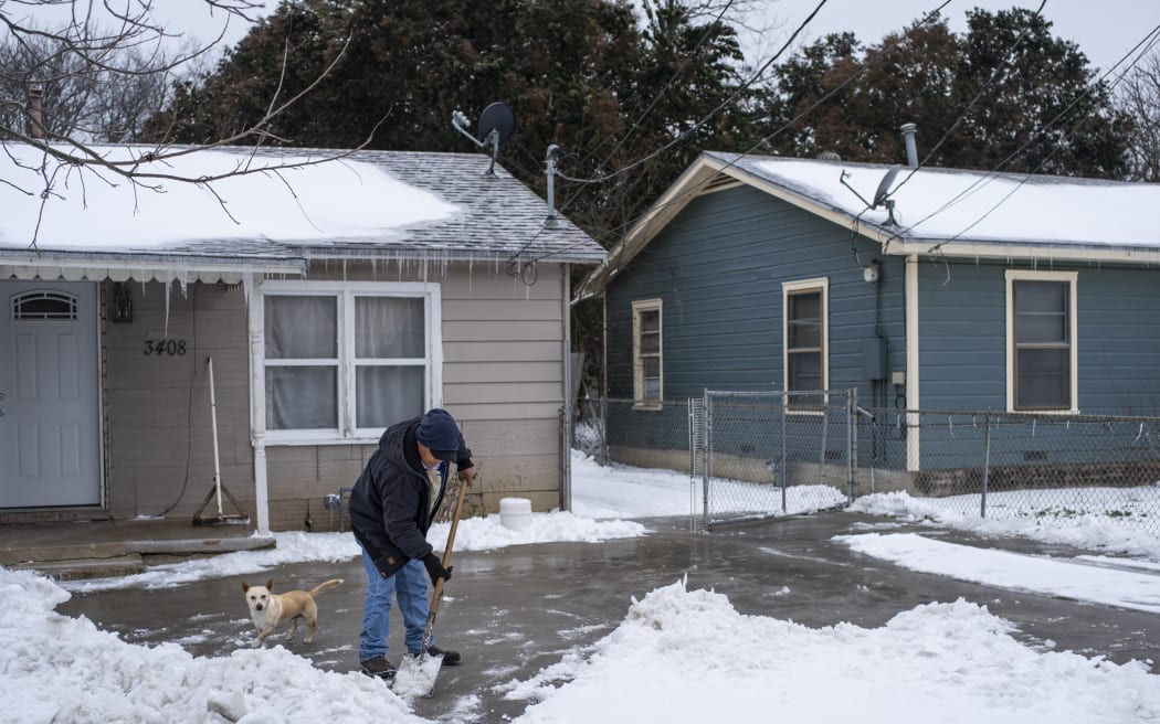 A Waco, Texas, resident clears snow from his driveway on 17 February 2021.