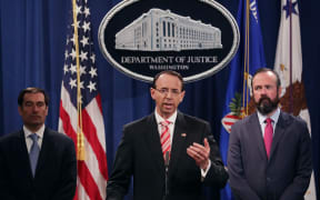 Deputy Attorney General Rod Rosenstein (C), Acting Principal Associate Deputy Attorney General Edward O'Callaghan (R) and Assistant Attorney General John Demers holds a news conference at the Department of Justice in Washington, DC.