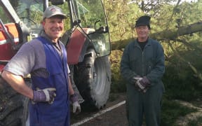 Cran Dalgetty and Murray Howard clear fallen trees in West Melton.