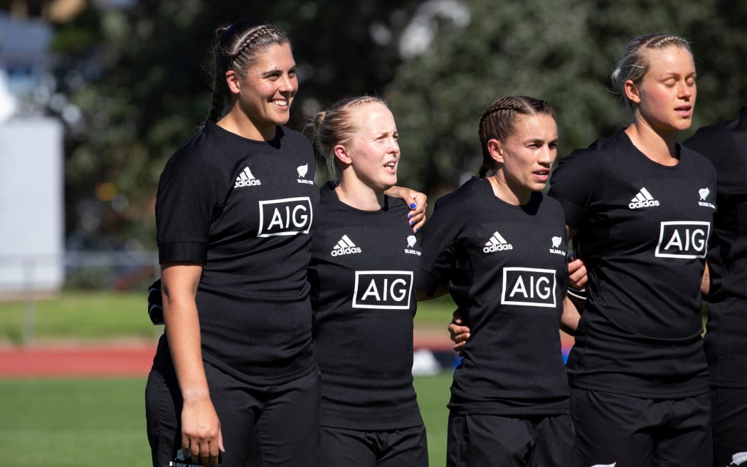 Black Ferns captain Eloise Blackwell (left) with Chelsea Alley (far right) during the national anthem before the match between the Black Ferns v New Zealand Barbarians, held at Trusts Stadium, Auckland, New Zealand.  =