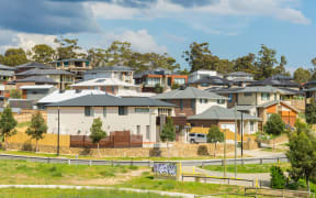 Melbourne, Australia - October 11, 2015: Row of new, modern suburban houses on the hill in Melbourne with trees during daytime.